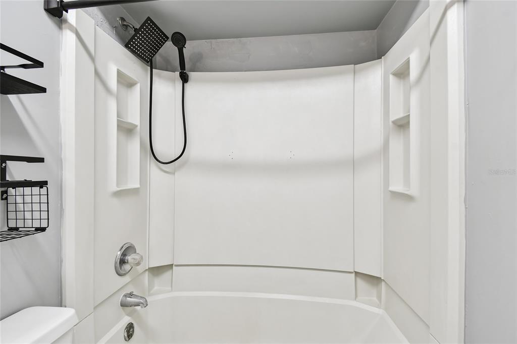 2480 Enterprise Road, Unit 6 Clearwater, FL 33763 - Photo 14 of 43 a bathroom with a bathtub and a shower