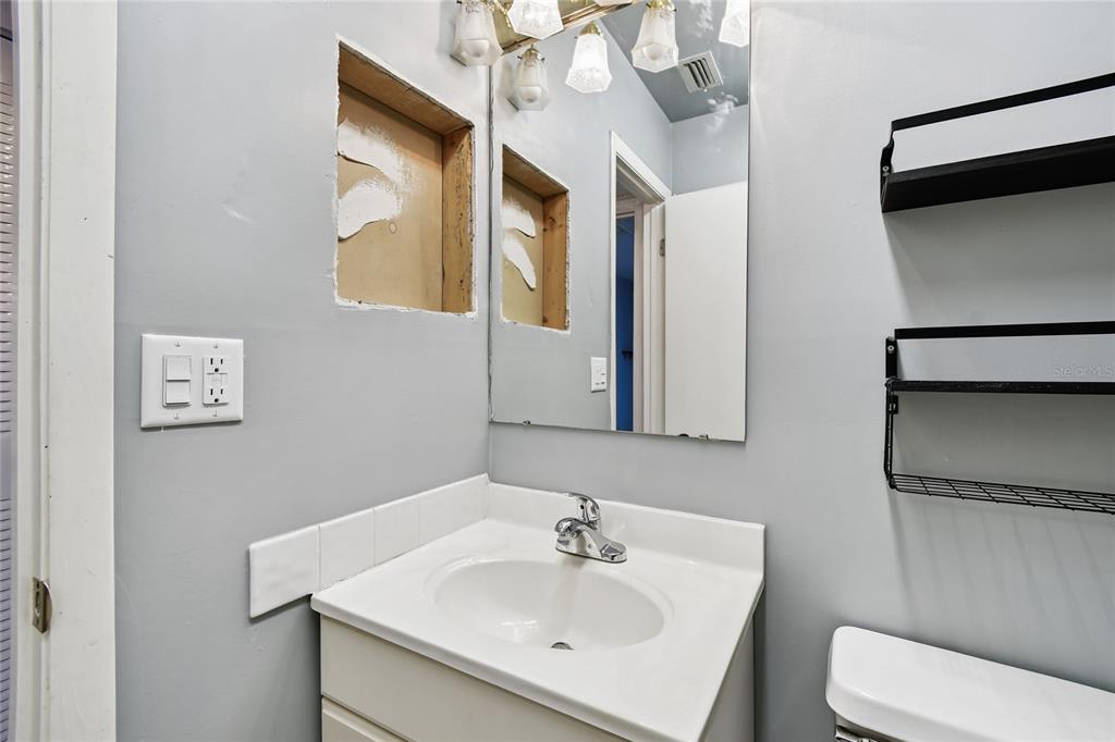 2480 Enterprise Road, Unit 6 Clearwater, FL 33763 - Photo 15 of 43 a bathroom with a sink and a mirror