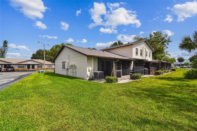 a view of a house with backyard porch and sitting area