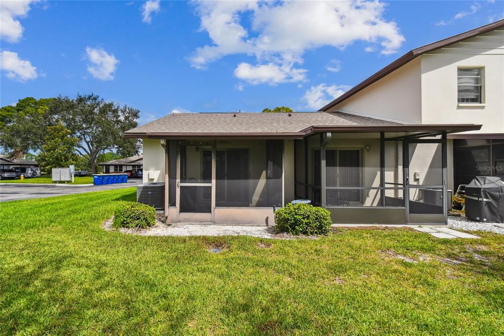 2480 Enterprise Road, Unit 6 Clearwater, FL 33763 - Photo 25 of 43 a front view of a house with garden and porch