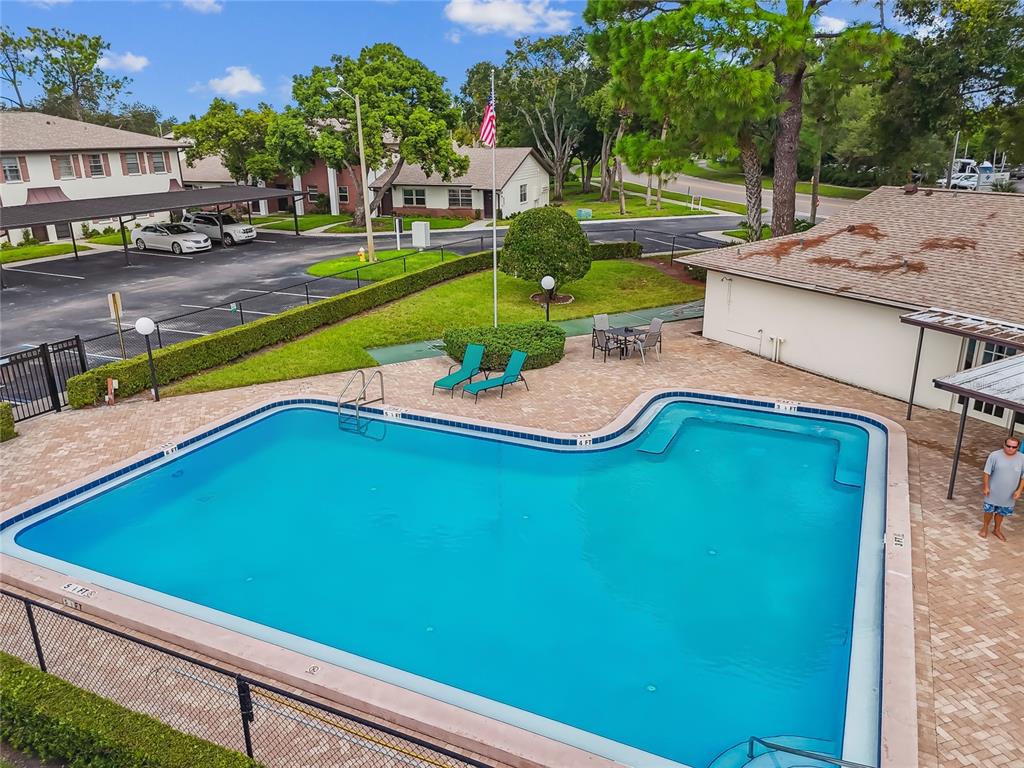 2480 Enterprise Road, Unit 6 Clearwater, FL 33763 - Photo 39 of 43 a view of a swimming pool with a yard