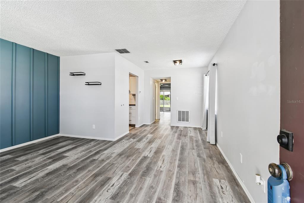 2480 Enterprise Road, Unit 6 Clearwater, FL 33763 - Photo 4 of 43 a view of a room with wooden floor and a bathroom