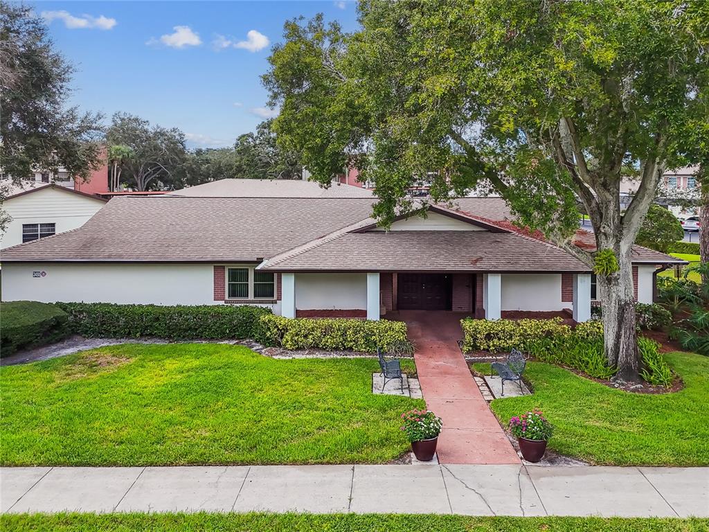 2480 Enterprise Road, Unit 6 Clearwater, FL 33763 - Photo 41 of 43 a front view of a house with garden
