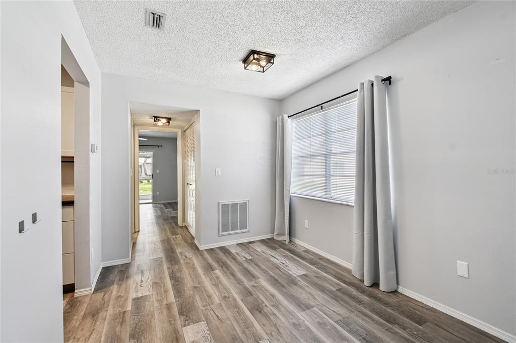 2480 Enterprise Road, Unit 6 Clearwater, FL 33763 - Photo 6 of 43 a view of empty room with wooden floor and fan