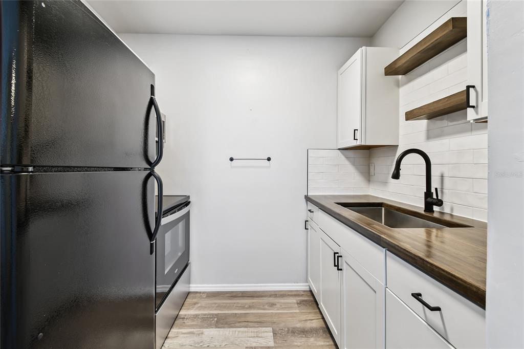 2480 Enterprise Road, Unit 6 Clearwater, FL 33763 - Photo 8 of 43 a kitchen with a sink and a refrigerator