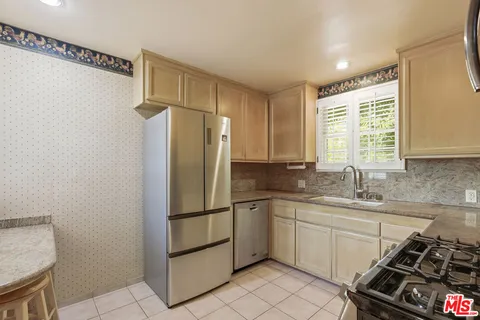 a kitchen with a sink appliances and cabinets