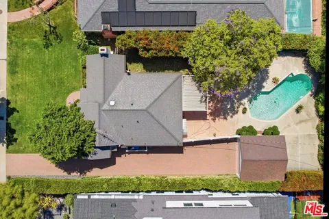 an aerial view of a house with a yard