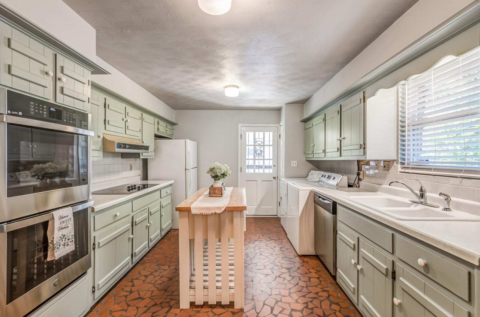 1675 Hayne Road Memphis, TN 38119 - Photo 8 of 25 a large kitchen with stainless steel appliances lots of counter space and wooden floor