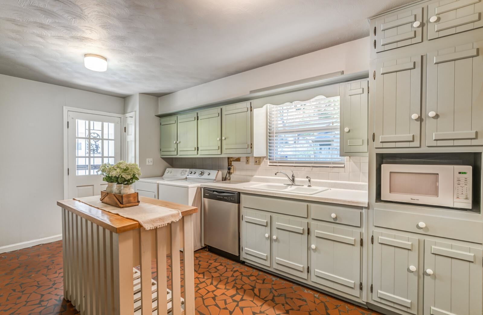 1675 Hayne Road Memphis, TN 38119 - Photo 9 of 25 a kitchen with white cabinets a sink and dishwasher