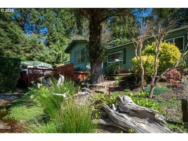 a view of backyard with plants and outdoor seating