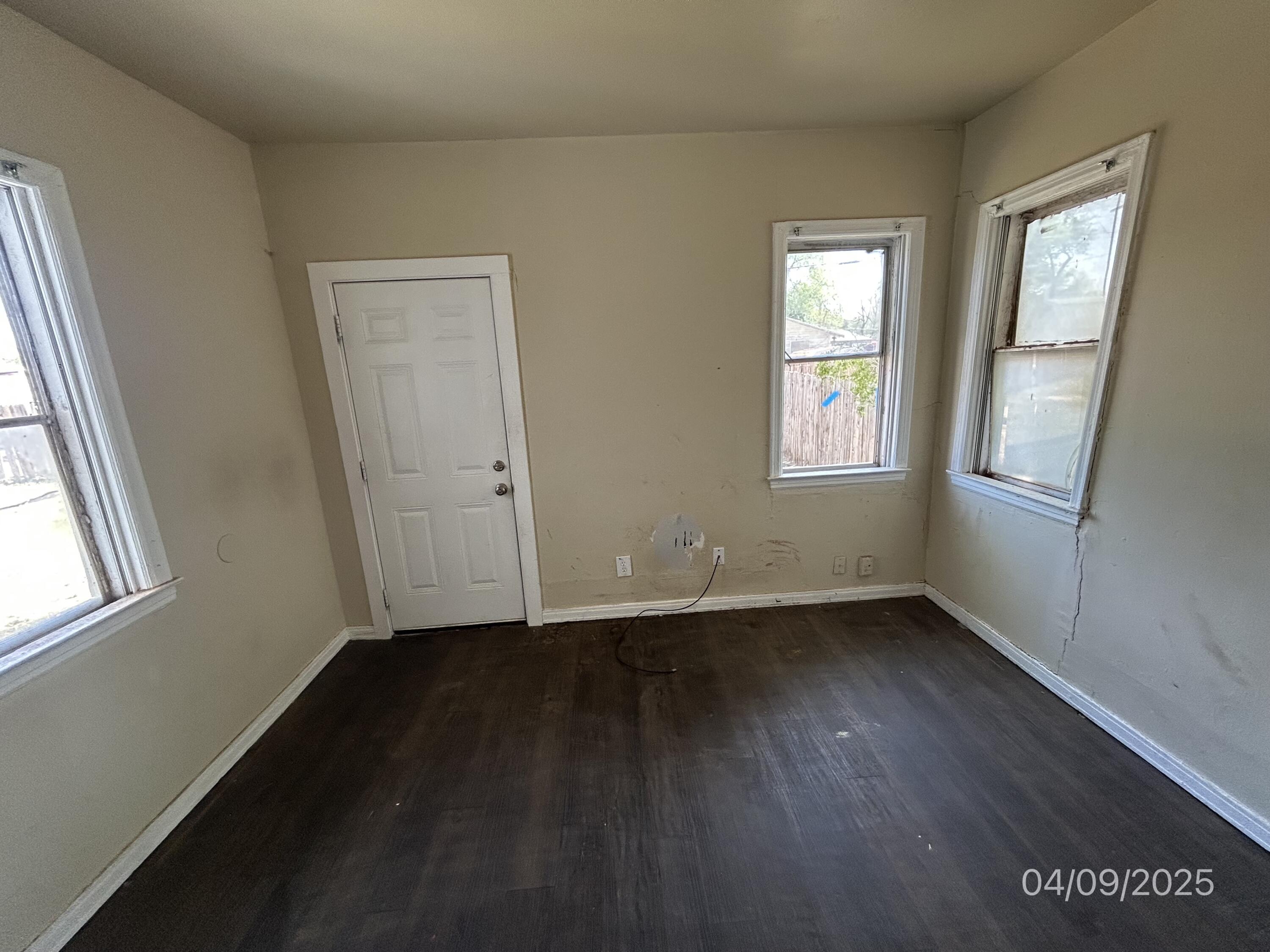 1921 Dixie Drive Lubbock, TX 79411 - Photo 12 of 19 an empty room with wooden floor and windows