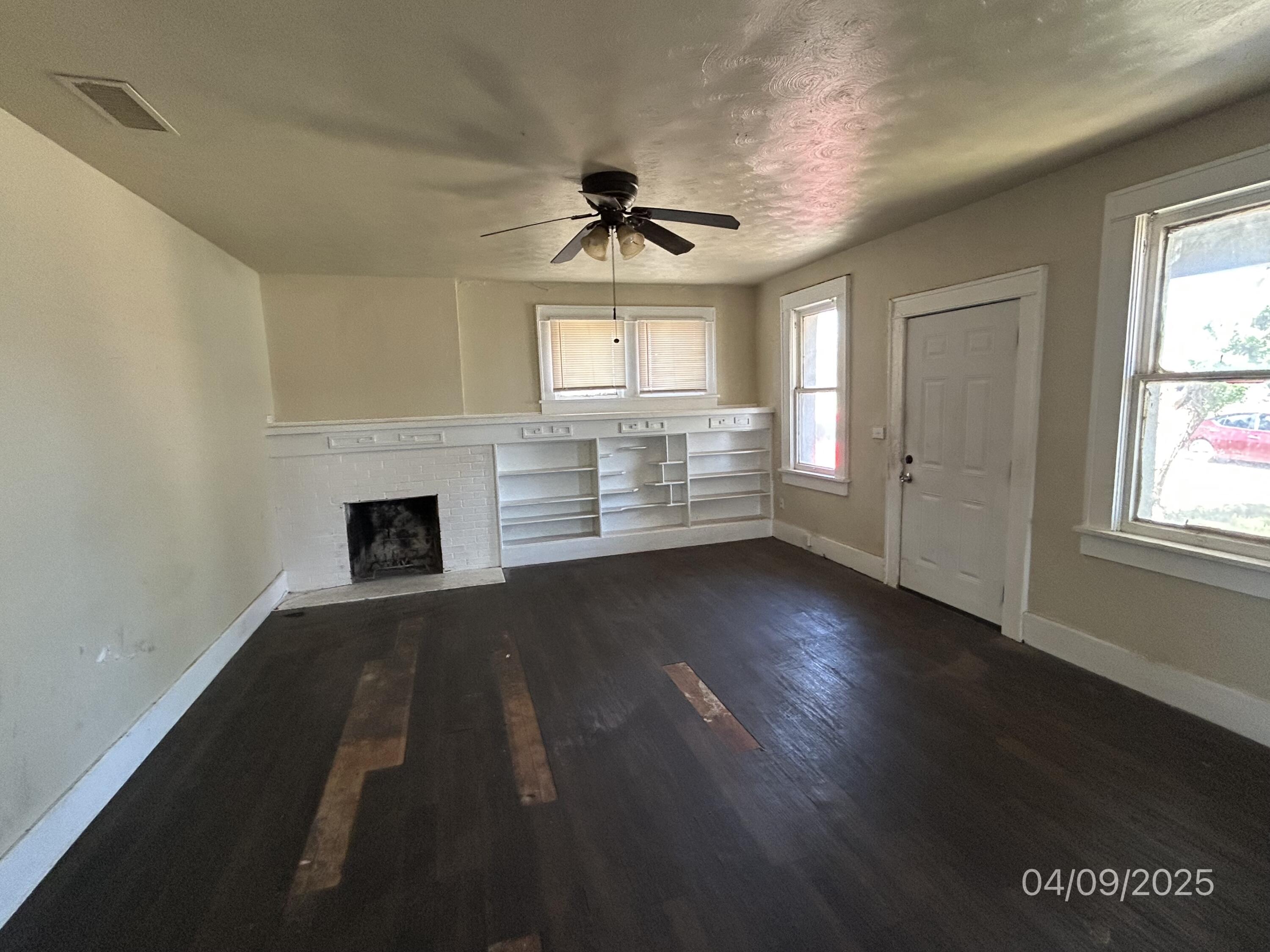 1921 Dixie Drive Lubbock, TX 79411 - Photo 4 of 19 wooden floor in an empty room with a window