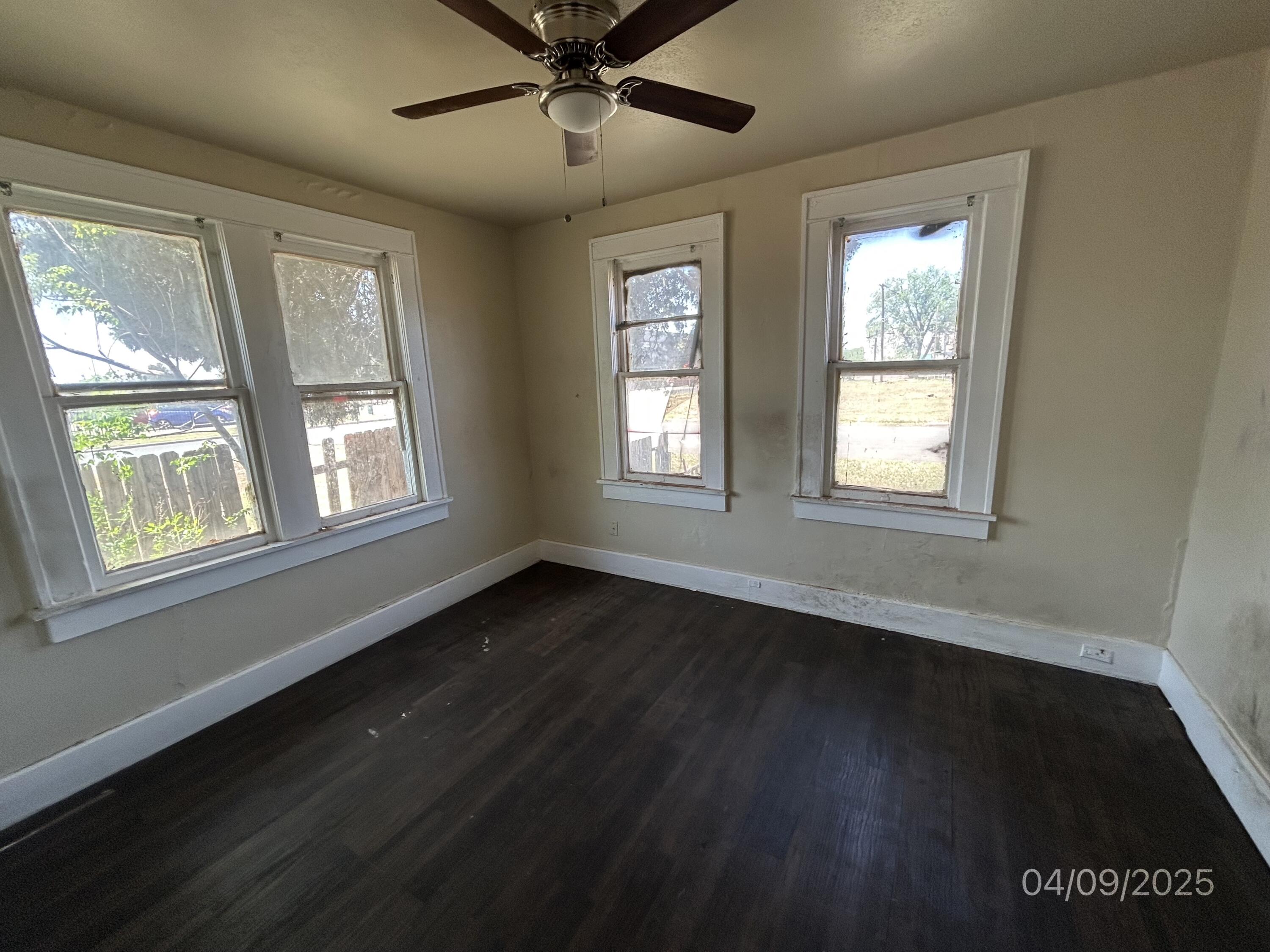 1921 Dixie Drive Lubbock, TX 79411 - Photo 9 of 19 a view of an empty room with wooden floor and a window