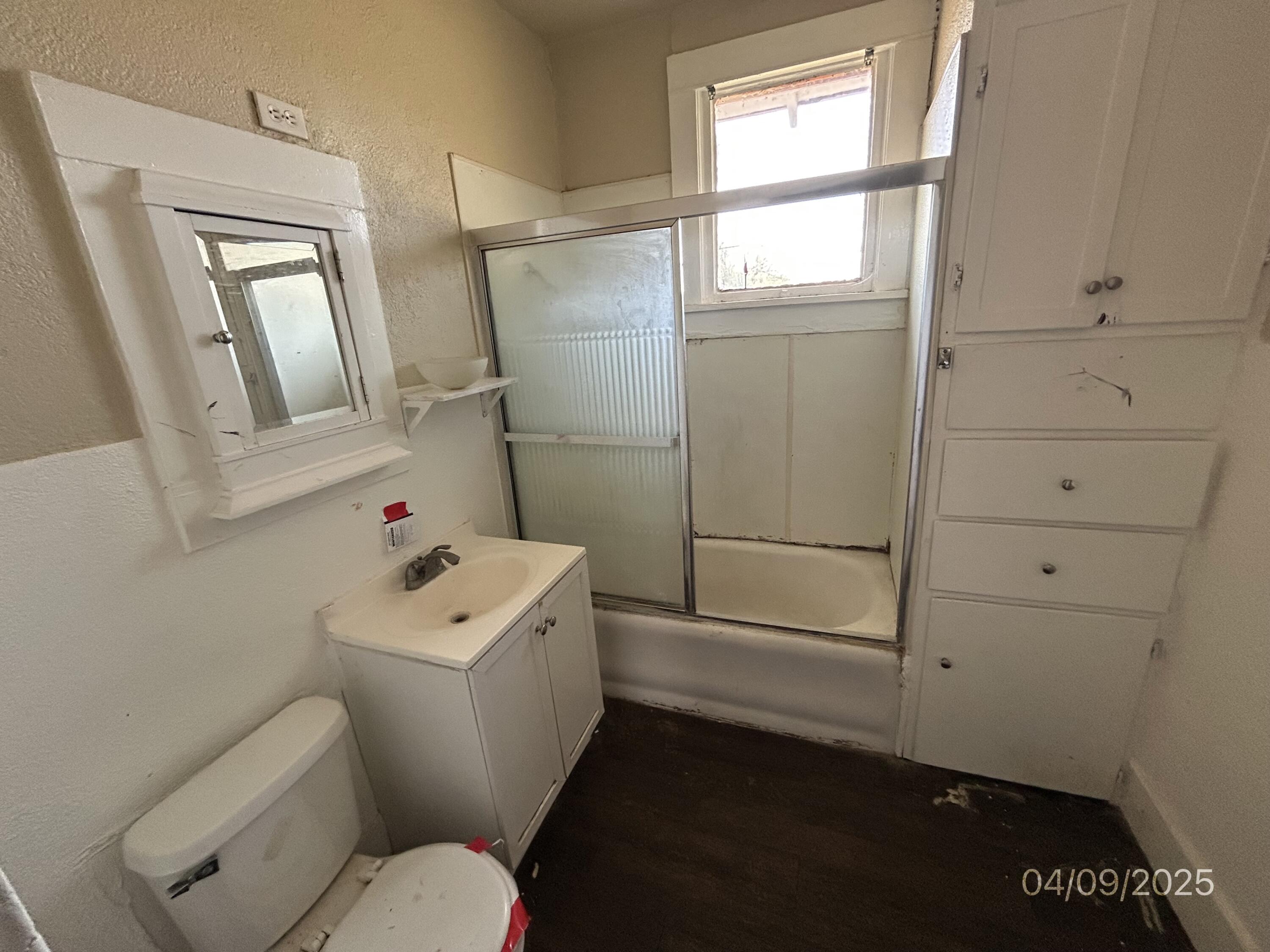 1921 Dixie Drive Lubbock, TX 79411 - Photo 10 of 19 a white toilet sitting next to a bathroom sink
