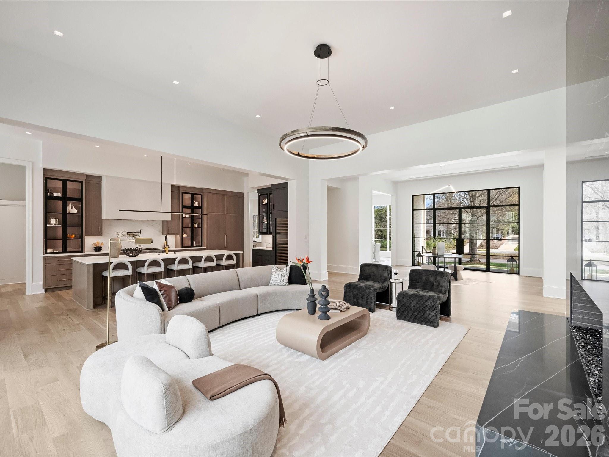 1436 Queens Road West Charlotte, NC 28207 - Photo 17 of 47 a living room with furniture a chandelier and a large window