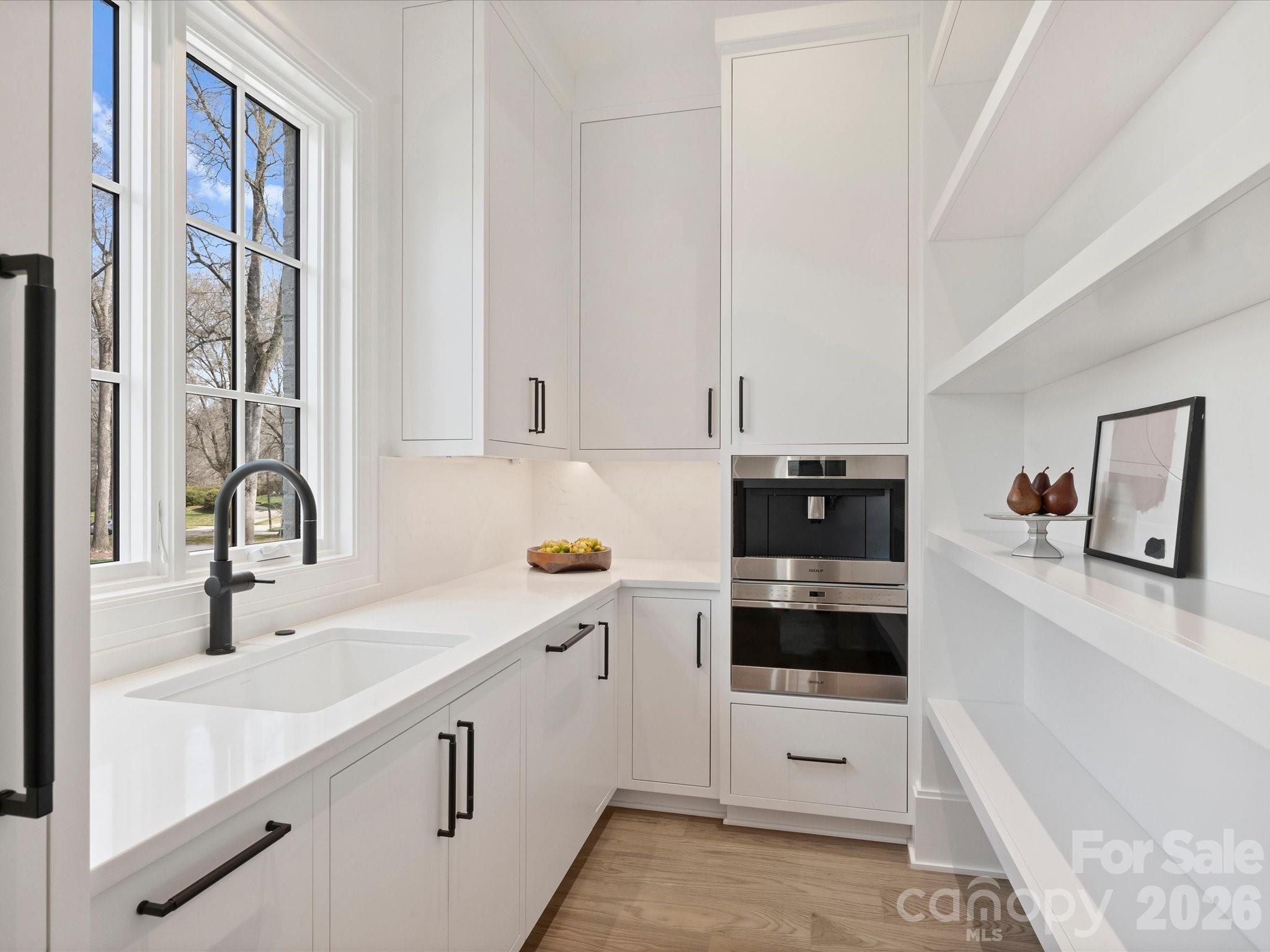 1436 Queens Road West Charlotte, NC 28207 - Photo 20 of 47 a view of a kitchen with a sink cabinets and wooden floor
