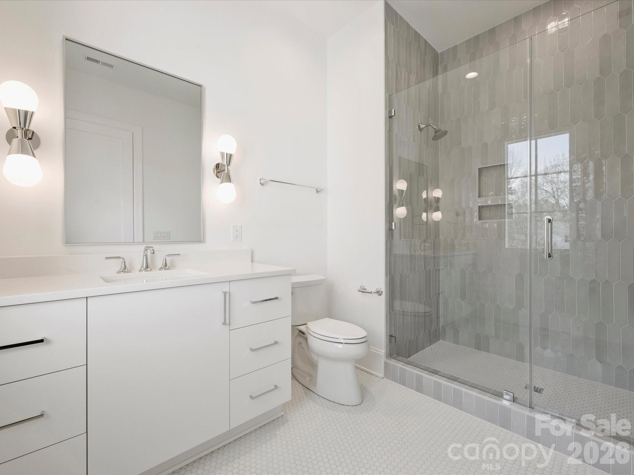 1436 Queens Road West Charlotte, NC 28207 - Photo 31 of 47 a bathroom with a double vanity sink toilet and shower