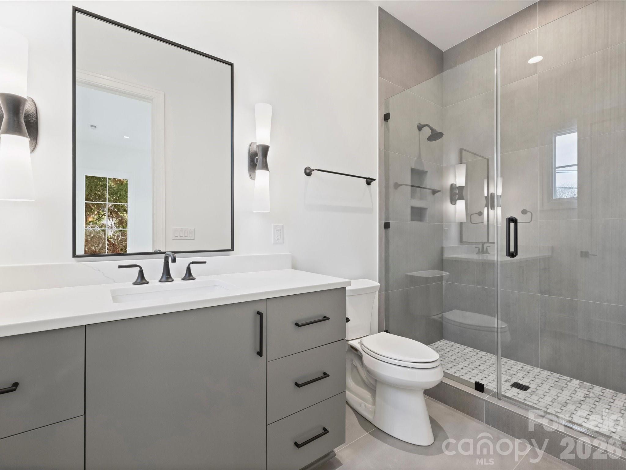 1436 Queens Road West Charlotte, NC 28207 - Photo 32 of 47 a bathroom with a sink toilet a mirror and shower