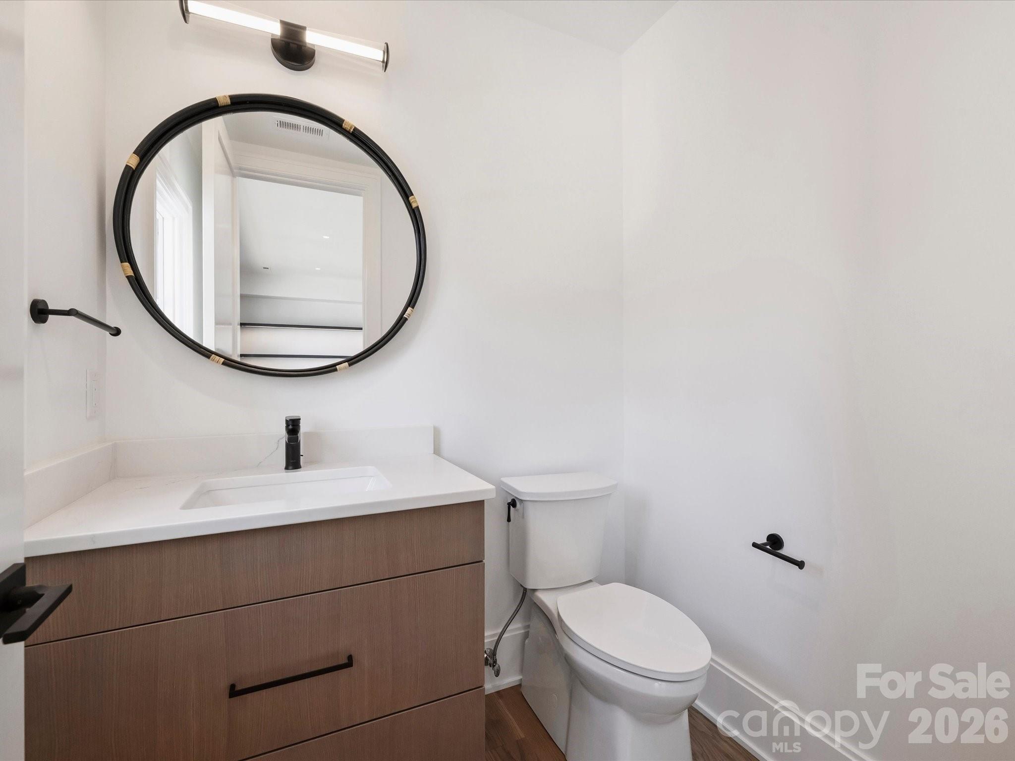 1436 Queens Road West Charlotte, NC 28207 - Photo 37 of 47 a bathroom with a toilet a sink and a mirror