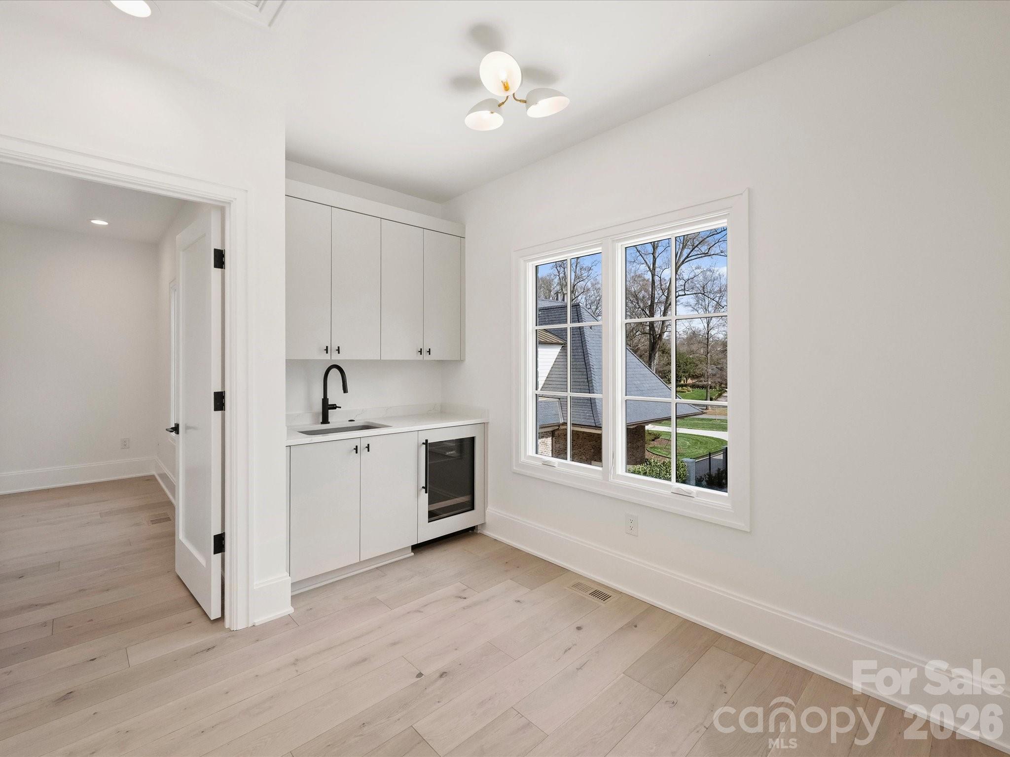 1436 Queens Road West Charlotte, NC 28207 - Photo 38 of 47 a view of a kitchen with white cabinets and window