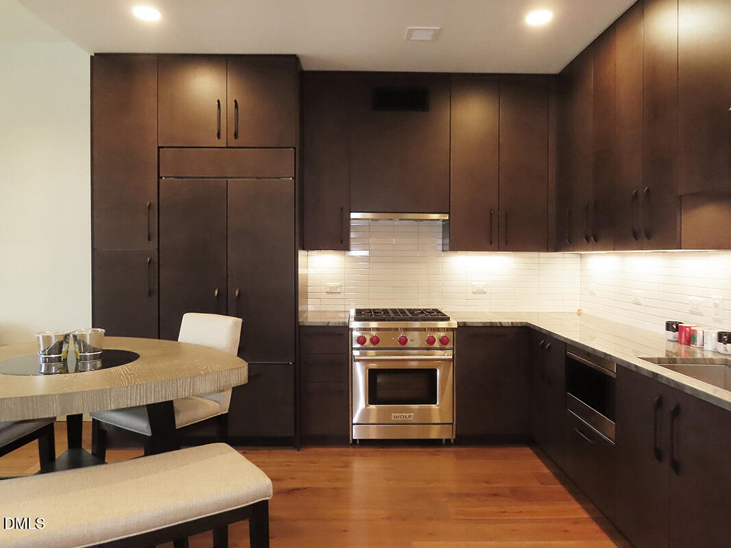 115 Morris Street, Unit 1908 Durham, NC 27701 - Photo 6 of 26 a kitchen with stainless steel appliances a stove a sink a microwave a refrigerator and cabinets