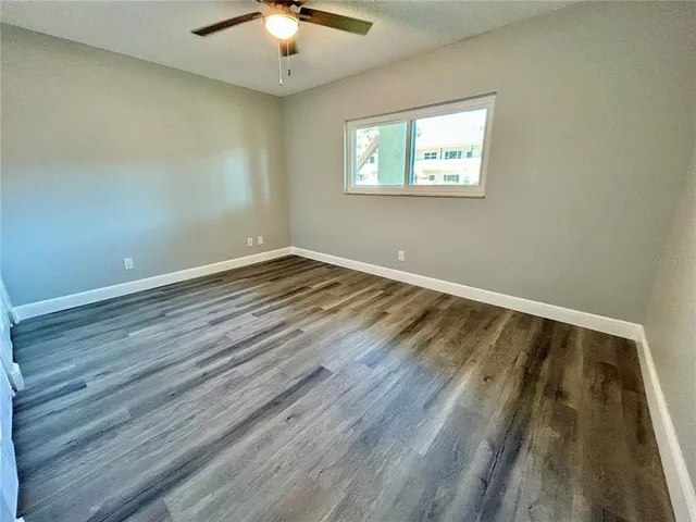 a view of wooden floor and brick walls
