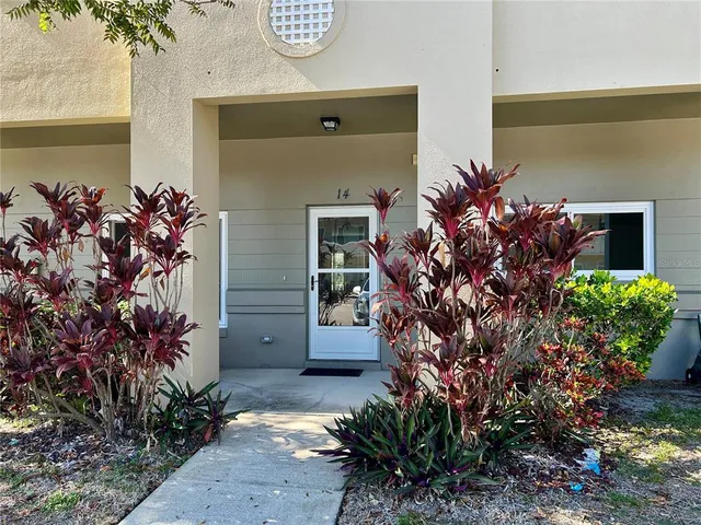 a view of an empty room with wooden floor and closet
