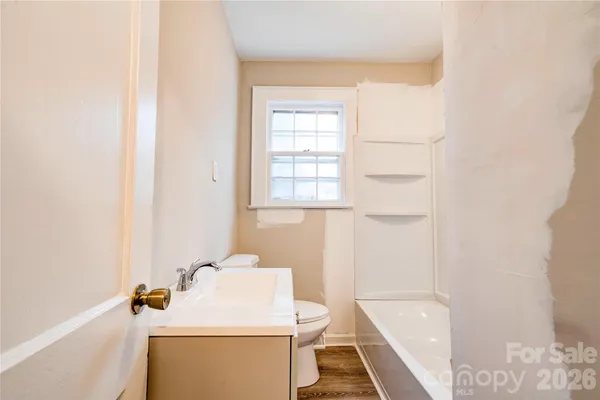 a bathroom with a sink a toilet and tub
