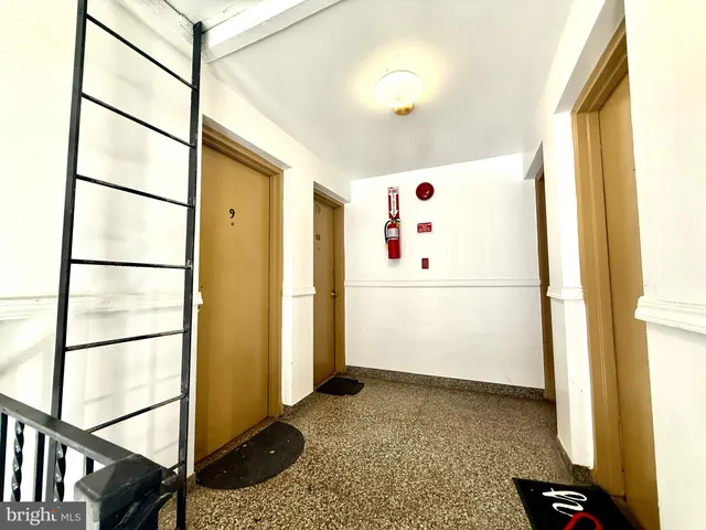 a view of a hallway with wooden floor and stairs