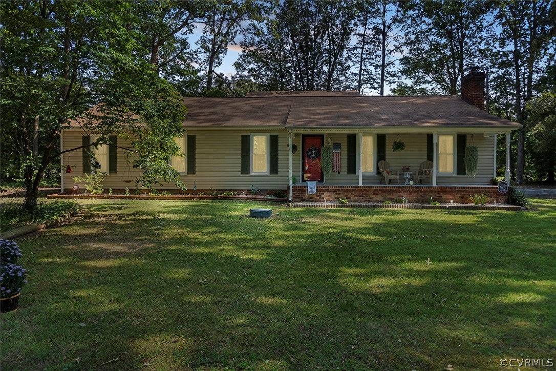 2820 Kinvan Road Richmond, VA 23231 - Photo 1 of 48 a front view of a house with a yard table and chairs