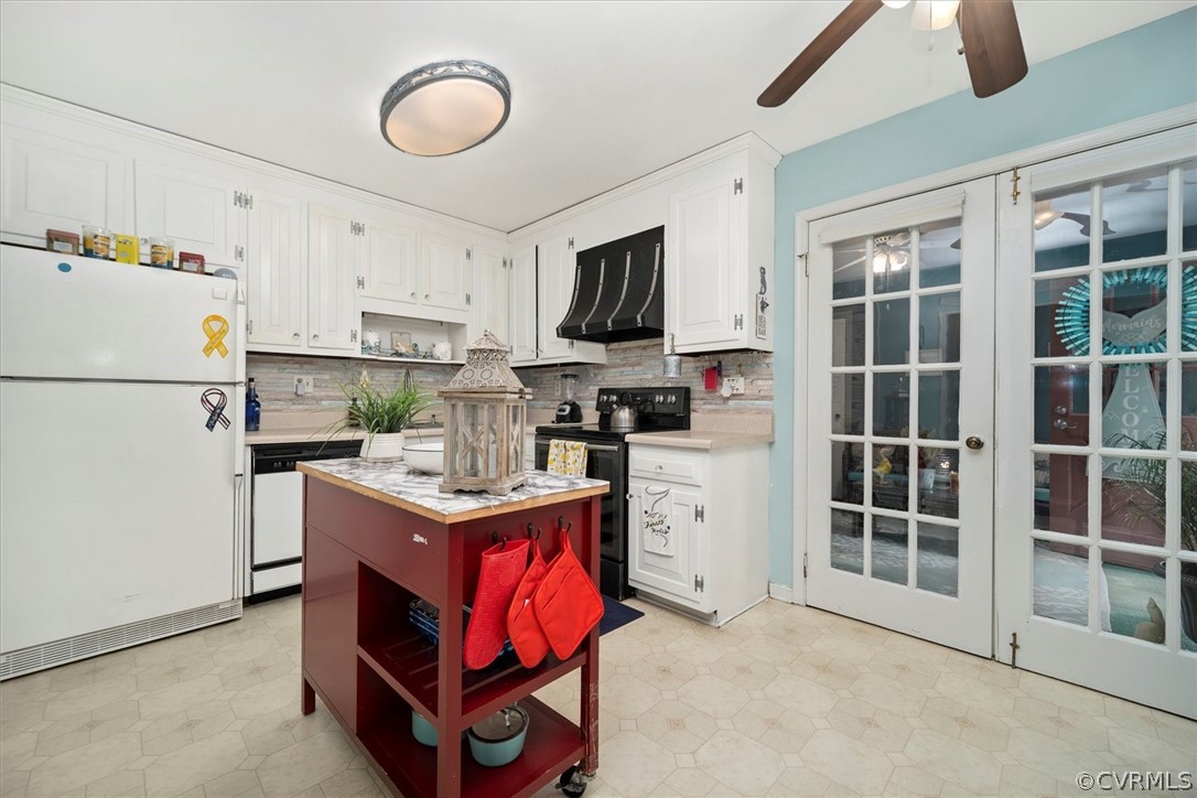 2820 Kinvan Road Richmond, VA 23231 - Photo 13 of 48 a kitchen with stainless steel appliances granite countertop a stove top oven a refrigerator a sink and dishwasher with white countertops with wooden floor