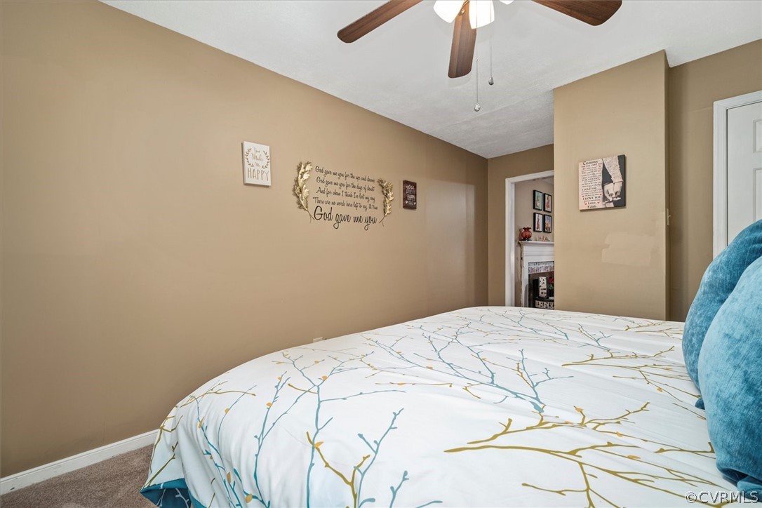 2820 Kinvan Road Richmond, VA 23231 - Photo 27 of 48 a bedroom with a bed and a chandelier