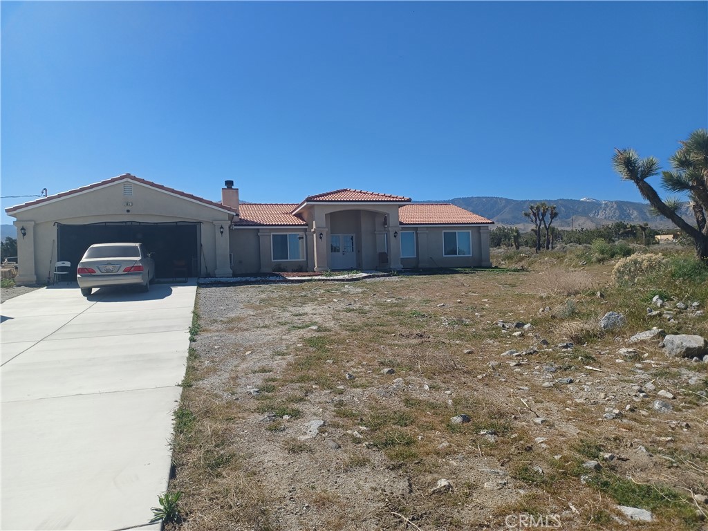 445 Solano Road Pinon Hills, CA 92372 - Photo 1 of 17 a view of a house with a yard and roof