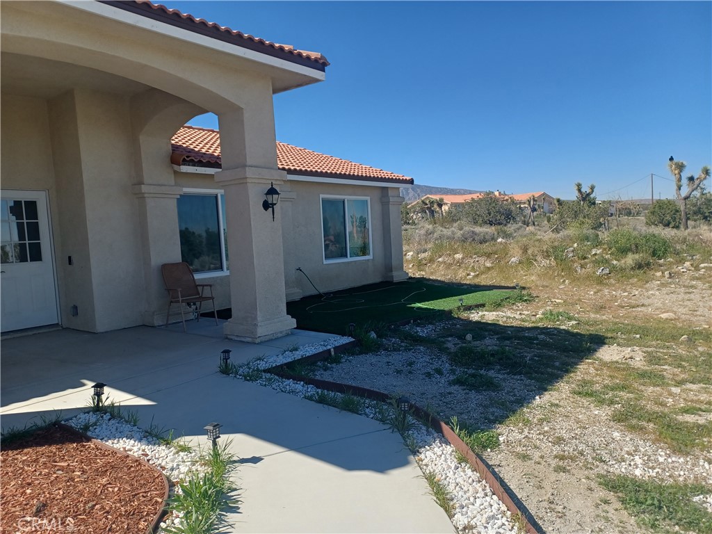 445 Solano Road Pinon Hills, CA 92372 - Photo 2 of 17 a front view of a house with a yard