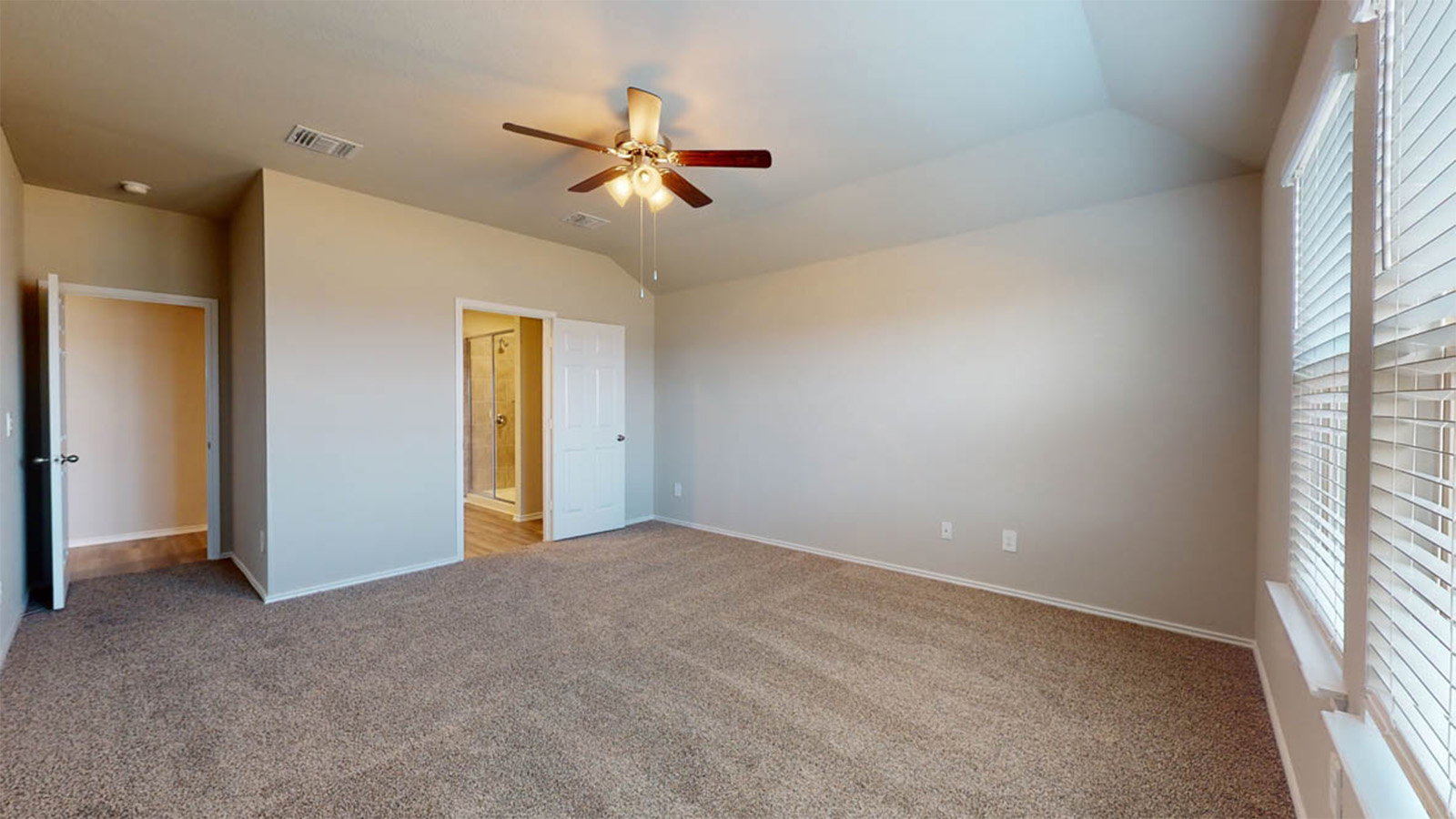 1217 Coriander Road Temple, TX 76501 - Photo 11 of 22 Spacious bedroom featuring plush carpeting, vaulted ceiling, and a ceiling fan with integrated lighting