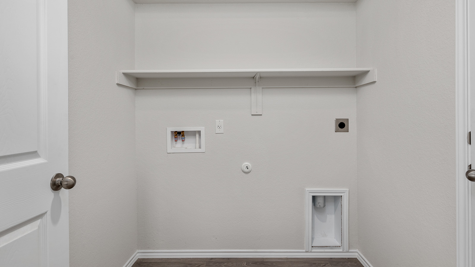 1217 Coriander Road Temple, TX 76501 - Photo 21 of 22 Dedicated utility space featuring a built-in shelving unit, white panel doors, and wood-finish flooring