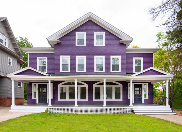 a front view of a house with swimming pool and porch