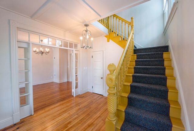 a view of entryway and hall with wooden floor