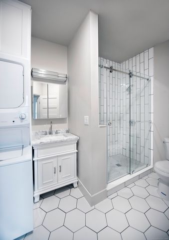 a bathroom with a sink mirror and shower