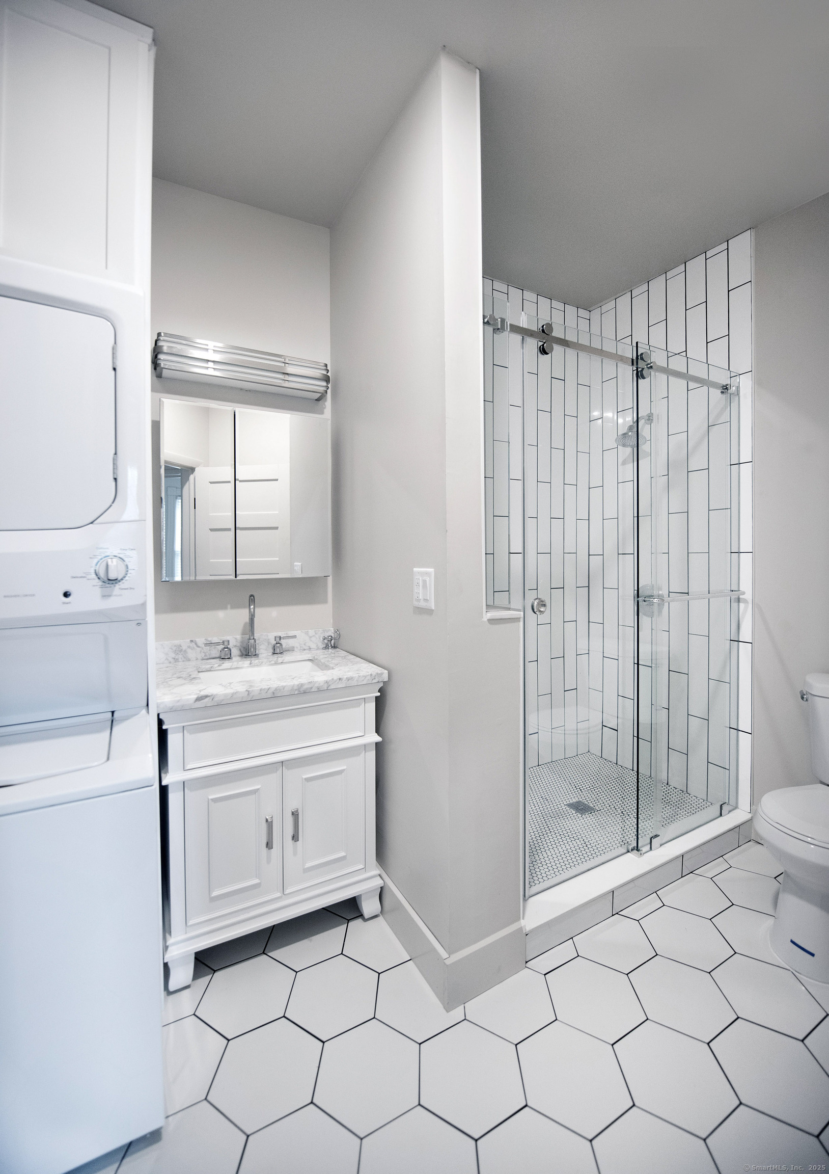 87 Broad Street Norwich, CT 06360 - Photo 12 of 29 a bathroom with a sink mirror and shower