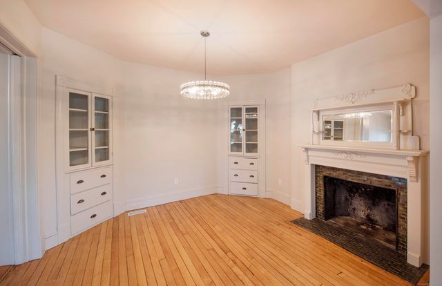 a bedroom with a bed and a fireplace