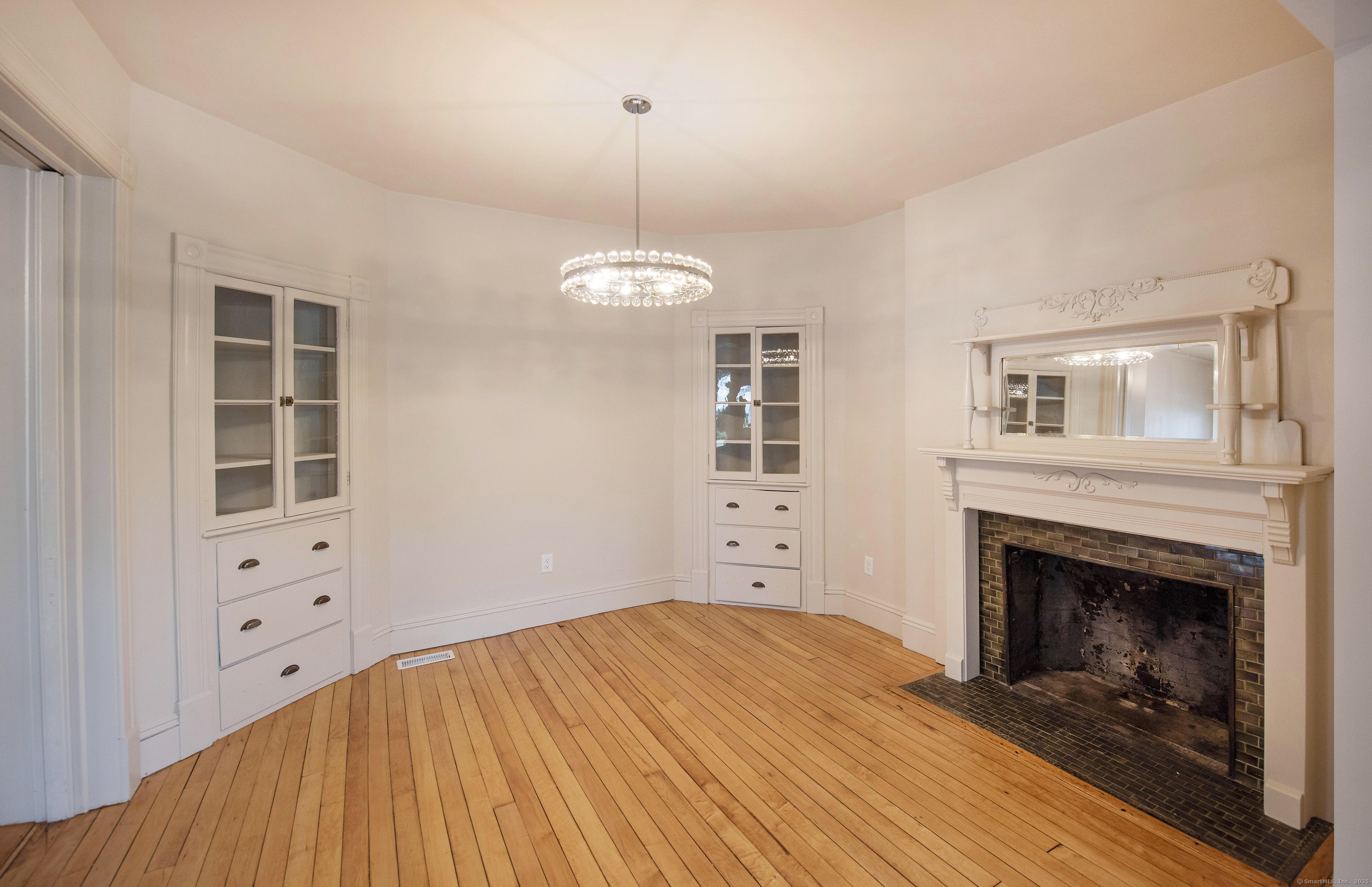 87 Broad Street Norwich, CT 06360 - Photo 14 of 29 a bedroom with a bed and a fireplace