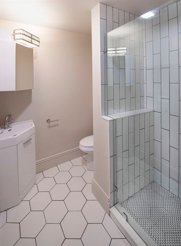 a bathroom with a sink toilet and shower