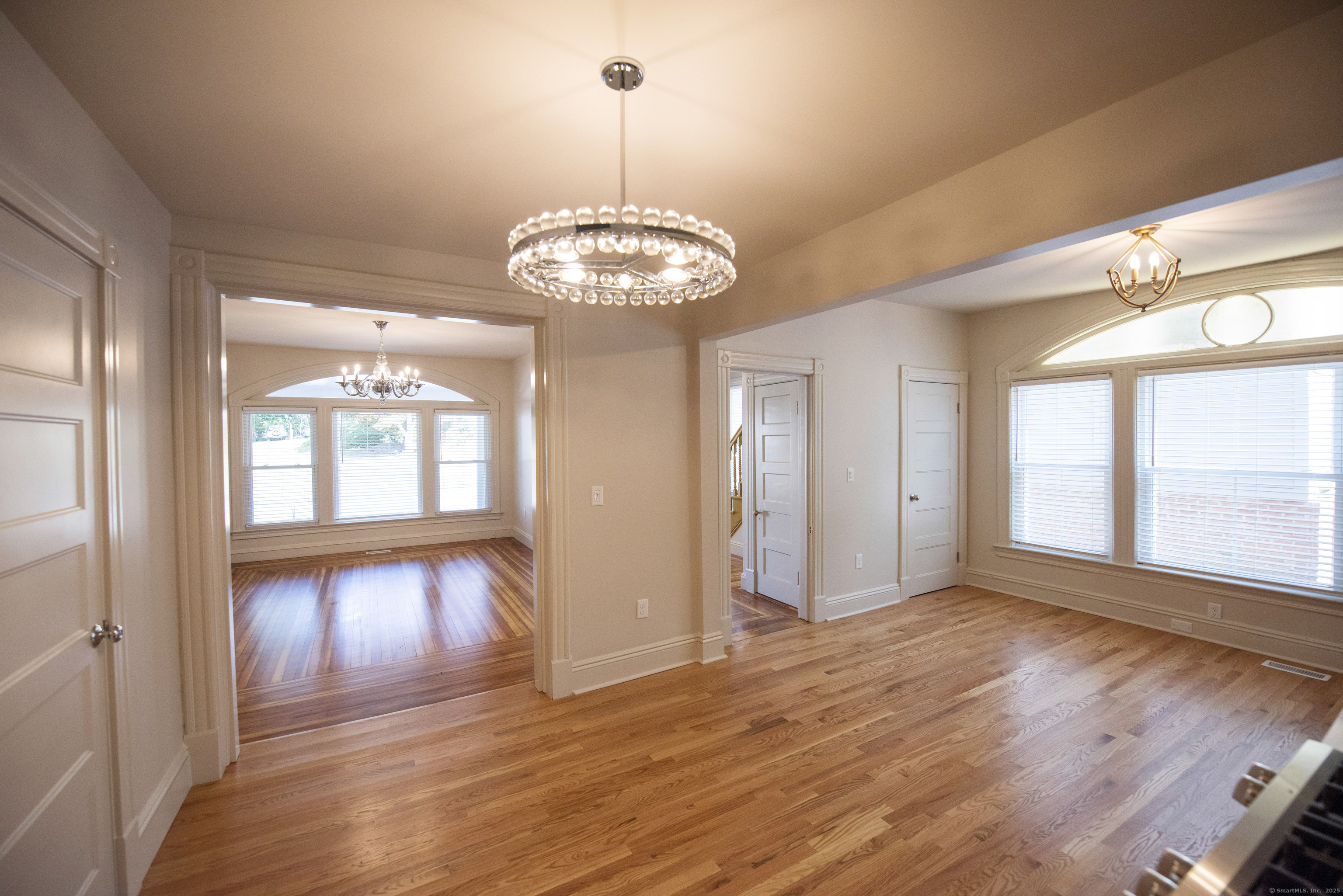 87 Broad Street Norwich, CT 06360 - Photo 20 of 29 a view of an empty room with wooden floor and a window