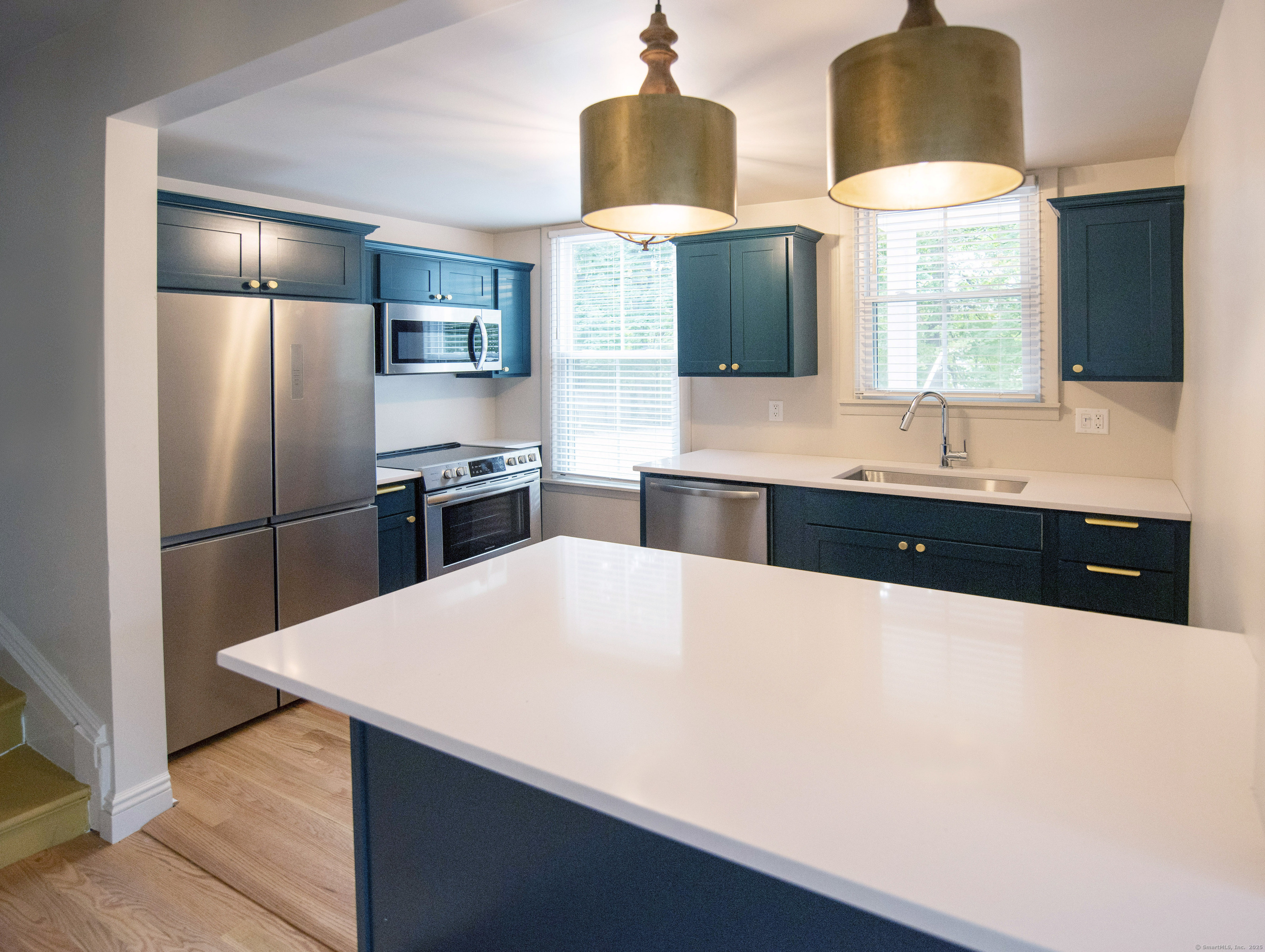 87 Broad Street Norwich, CT 06360 - Photo 2 of 29 a kitchen with stainless steel appliances a sink and a refrigerator