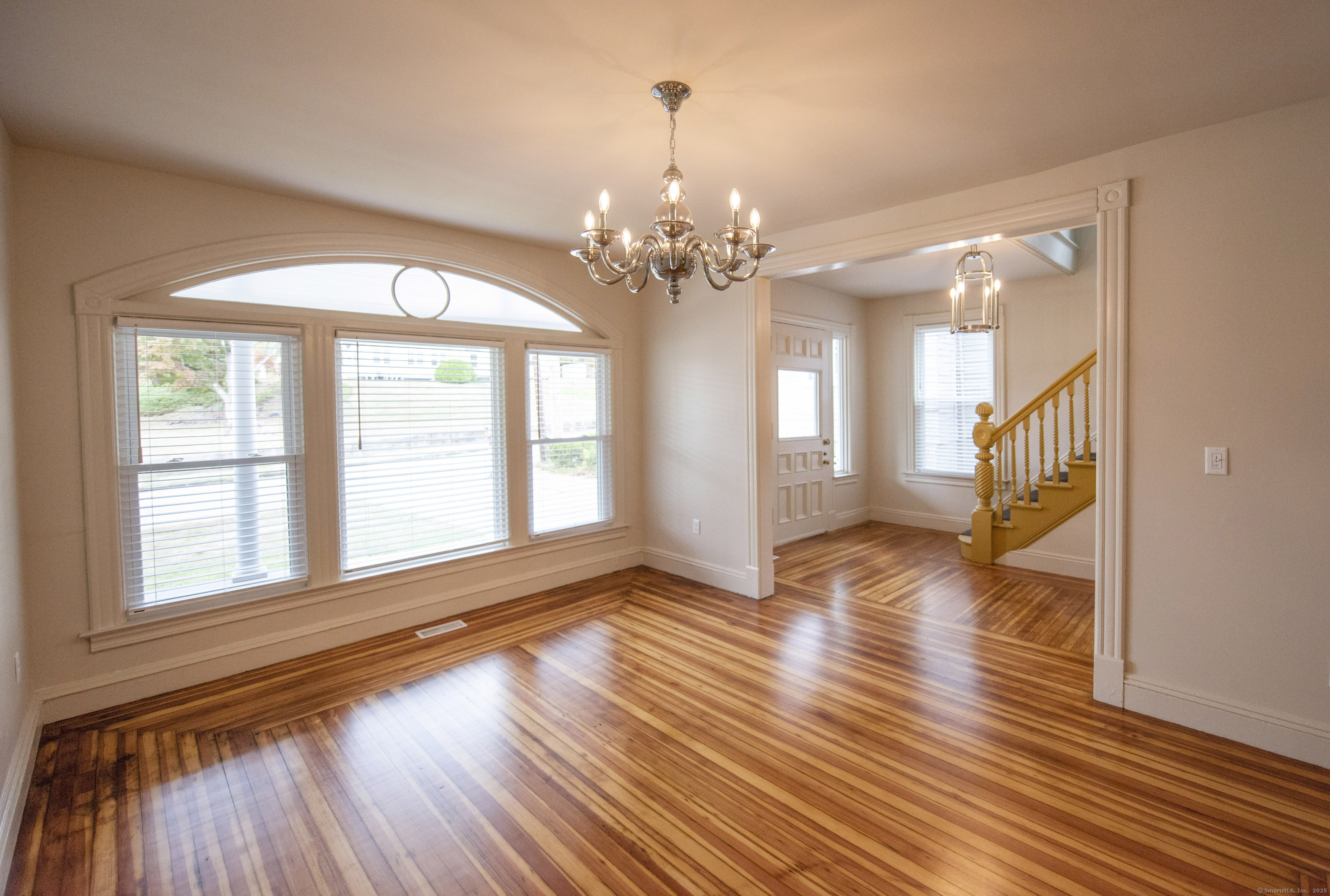 87 Broad Street Norwich, CT 06360 - Photo 21 of 29 a view of an empty room with wooden floor and a window