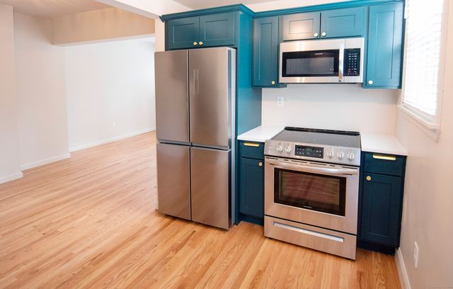 a kitchen with a refrigerator stove and microwave