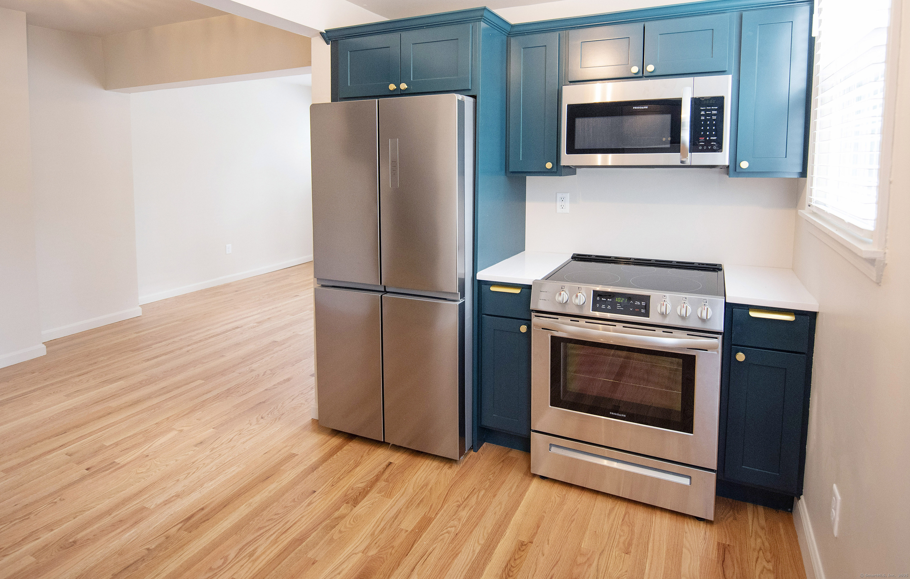 87 Broad Street Norwich, CT 06360 - Photo 24 of 29 a kitchen with a refrigerator stove and microwave