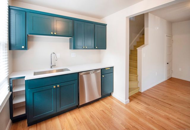 a kitchen with a sink and a refrigerator