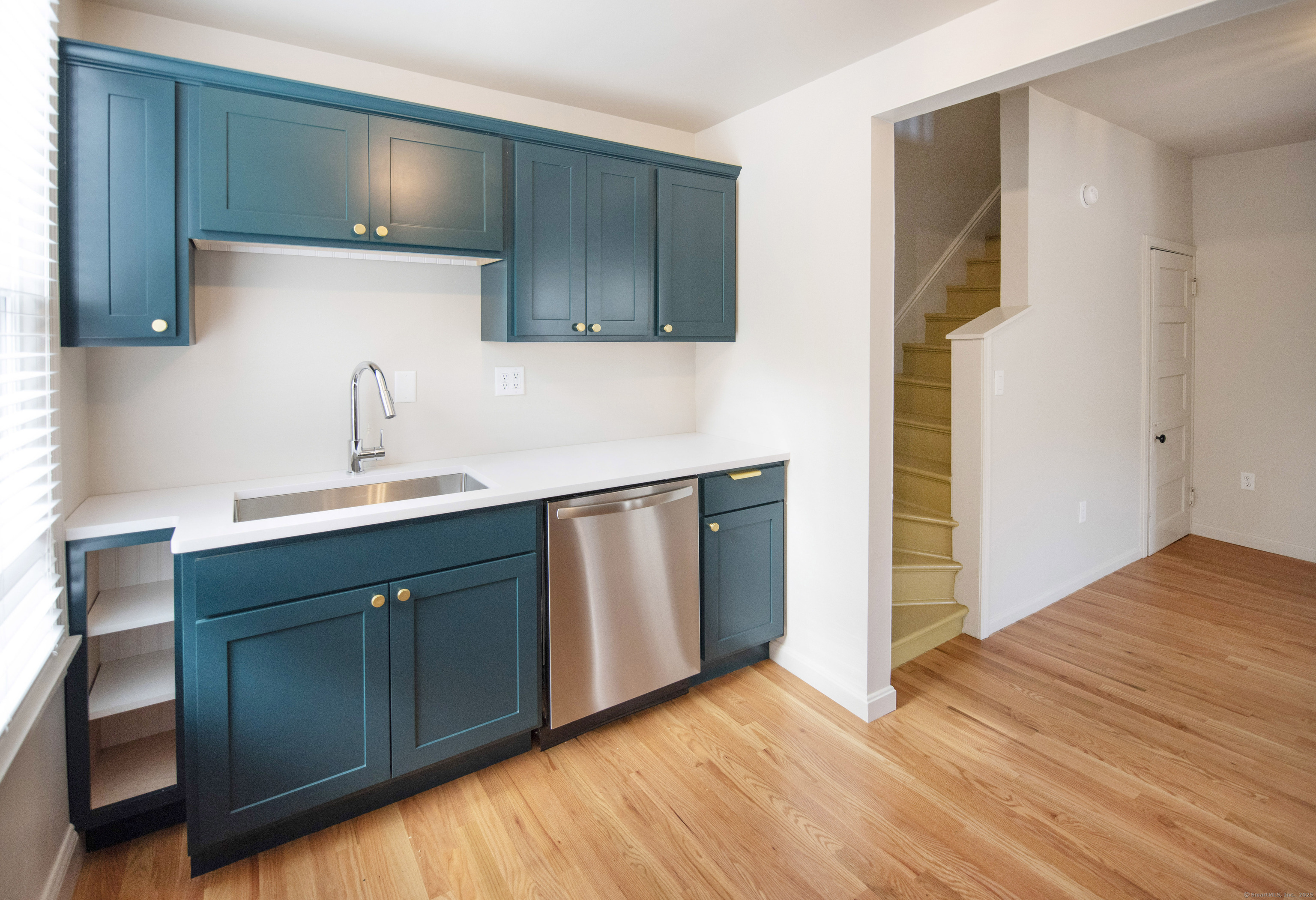 87 Broad Street Norwich, CT 06360 - Photo 25 of 29 a kitchen with a sink and a refrigerator